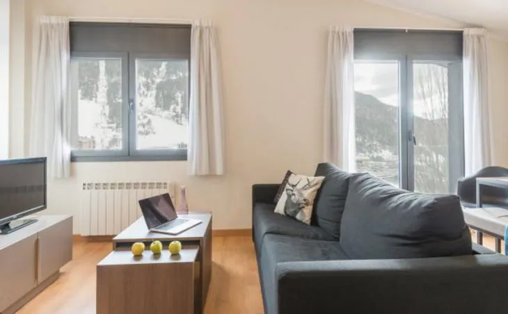 Ski Holidays El Tarter. A living room with TV and sofas at self-catered apartments, Residence Andorra El Tarter, Andorra