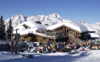 Snow covered roofs on wooden alpine buildings at the Austrian ski resort of Saalbach Hinterglemm