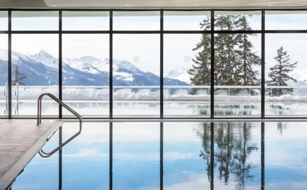 A beautiful swimming pool with a stunning Alpine view at Club Med Les Arcs