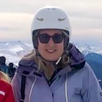 Photo of Liz Tarrant, Senior Sales Advisor on a ski trip with mountains in the background