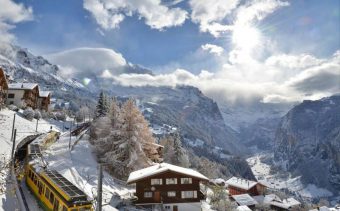 Mountain railway and snow covered chalets in Wengen, Switzerland